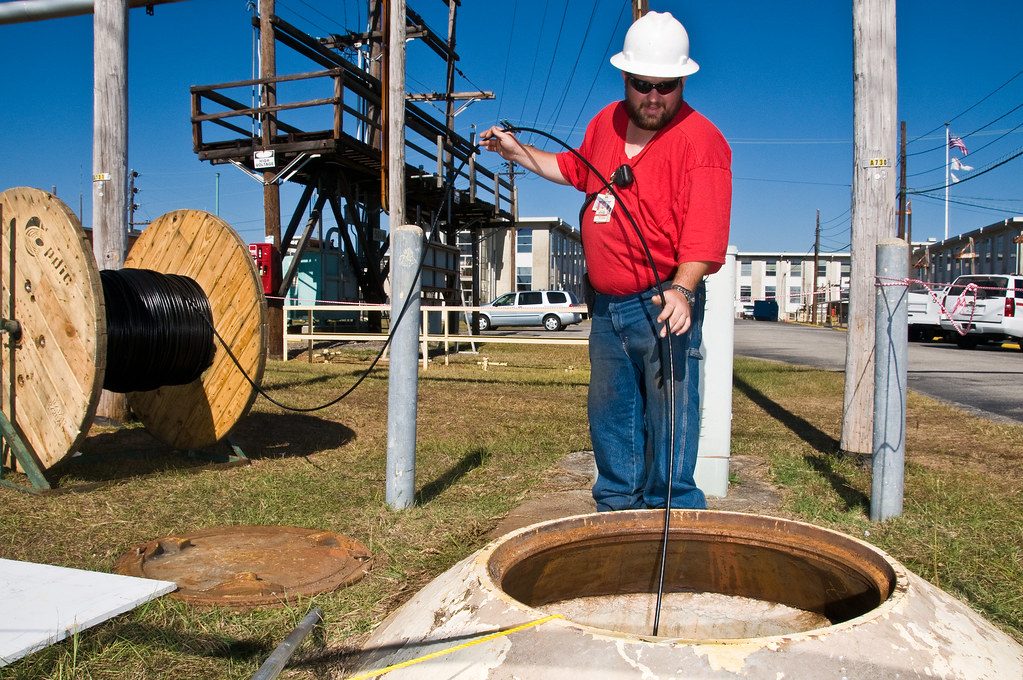 Technician working in a fibre manhole